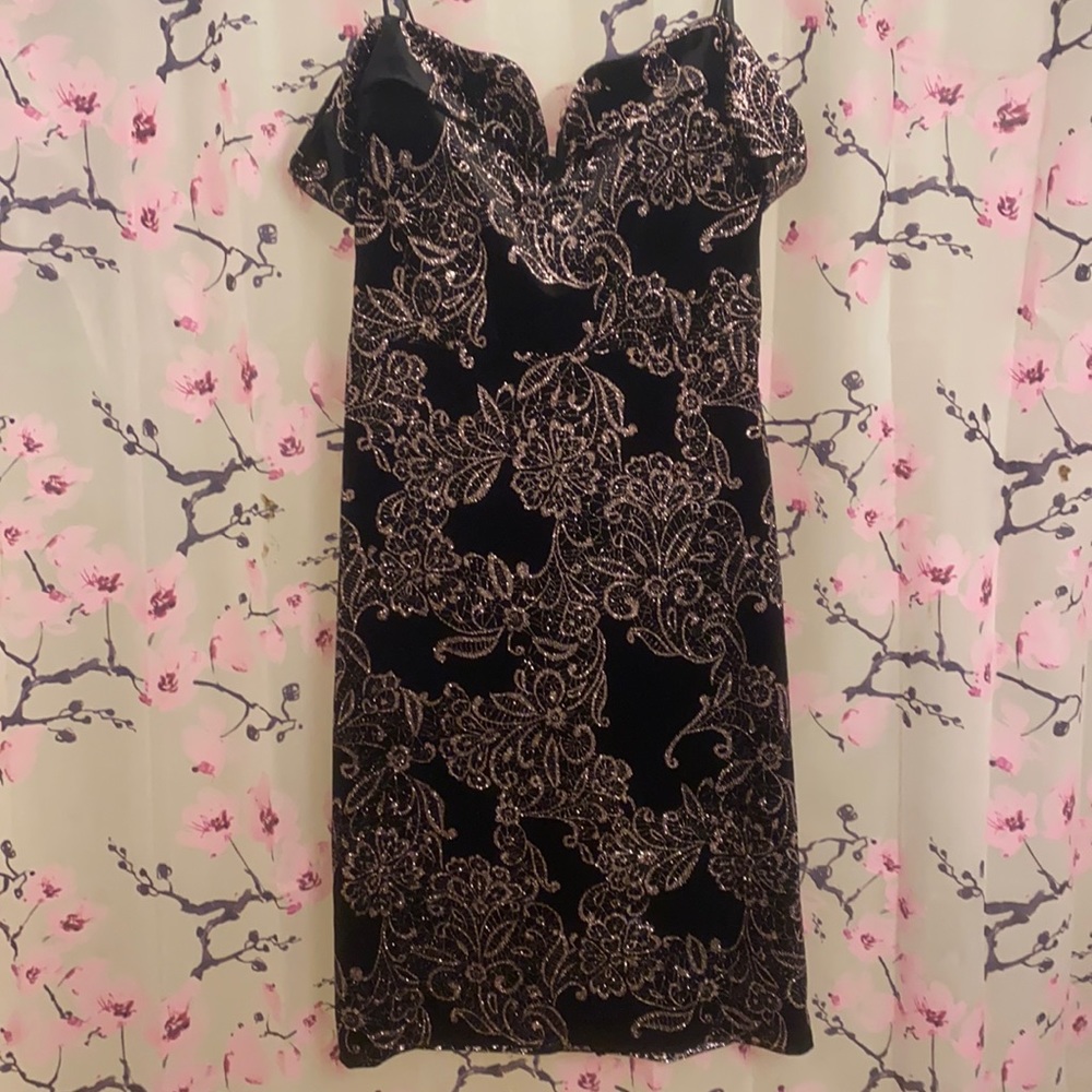 Off shoulder black dress, with flower glitter accents.